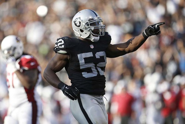 Oakland Raiders outside linebacker Khalil Mack (52) reacts after sacking Arizona Cardinals quarterback Carson Palmer during the first half of an NFL preseason football game in Oakland, Calif., Sunday, Aug. 30, 2015. (AP Photo/Tony Avelar)