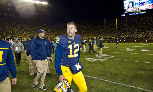 Michigan punter Blake O'Neill (12) walks off the field after an NCAA college football game against Michigan State in Ann Arbor, Mich., Saturday, Oct. 17, 2015. Michigan State's Jalen Watts-Jackson grabbed a flubbed punt by O'Neill and lumbered 38 yards into the end zone for a touchdown on the final play of the game, giving No. 7 Michigan State a shocking 27-23 win over No. 12 Michigan. (AP Photo/Tony Ding) ORG XMIT: AAS107