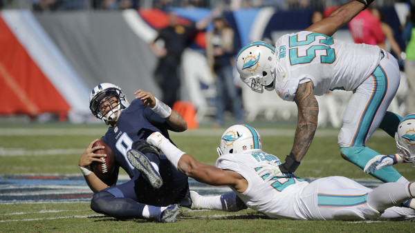 Tennessee Titans quarterback Marcus Mariota (8) is sacked by Miami Dolphins defensive end Olivier Vernon (50) in the first half of an NFL football game Sunday, Oct. 18, 2015, in Nashville, Tenn. (AP Photo/James Kenney)