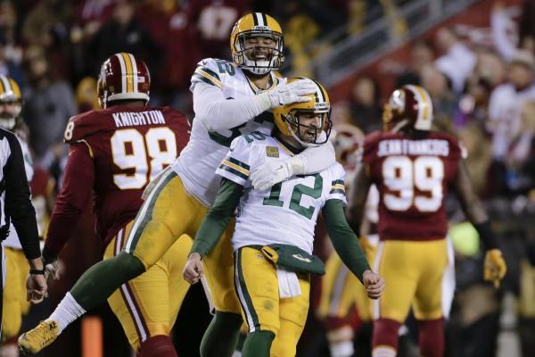 Green Bay Packers tight end Richard Rodgers (82) celebrates with quarterback Aaron Rodgers (12) after wide receiver Davante Adams caught a touchdown pass during the first half of an NFL wild-card playoff football game against the Washington Redskins in Landover, Md., Sunday, Jan. 10, 2016. (AP Photo/Mark Tenally)
