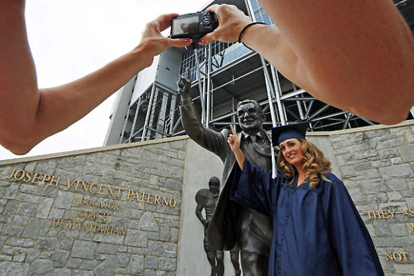 Weeks before the statue was removed, Gina DiJohnson posed in a cap and gown with the statue on July 11, 2012, a day before the Freeh Report on the Jerry Sandusky child sex scandal at Penn State was released.