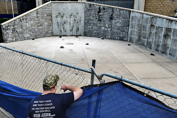 The following day, a man stares at the site where the statue of former Penn State University football coach Joe Paterno once stood outside Beaver Stadium. The statue was removed by workers after Penn State's president Rodney Erickson made the decision, in the wake of the child sex scandal of former assistant football coach Jerry Sandusky.