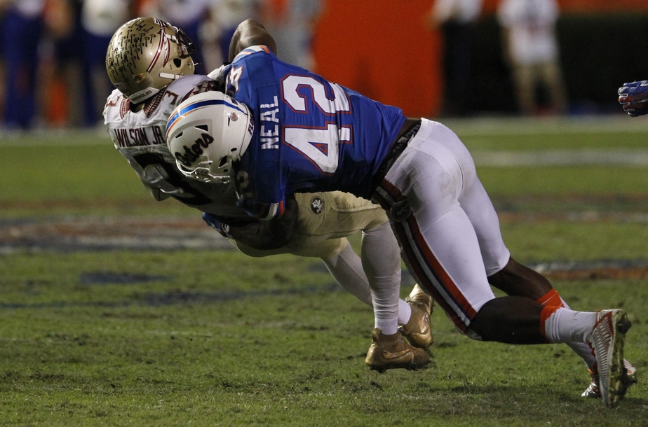 28 November 2015: Florida Gators defensive back Keanu Neal (42) tackles Florida State Seminoles wide receiver Jesus Wilson (3) during the NCAA football game between the Florida State Seminoles and the Florida Gators at Ben Hill Griffin Stadium at Florida Field in Gainesville, FL. (Photo by Mark LoMoglio/Icon Sportswire)