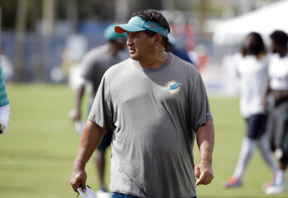 Miami Dolphins offensive coordinator Clyde Christensen walks off the field, Monday, Aug. 15, 2016, after practice at NFL football training camp in Davie, Fla. (AP Photo/Lynne Sladky)