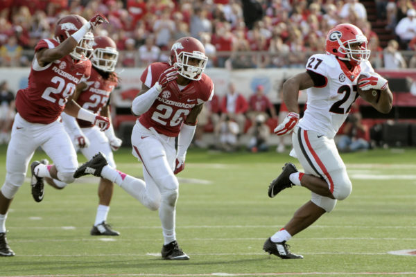 Georgia running back Nick Chubb (27) outruns Arkansas cornerback Jared Collins (29), safety Rohan Gaines (26) and safety Alan Turner (27) for a 43-yard touchdown rush in the second quarter of an NCAA college football game in Little Rock, Ark., Saturday, Oct. 18, 2014. (AP Photo/David Quinn)