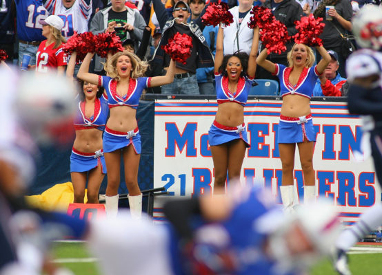 ORCHARD PARK, NY - SEPTEMBER 30: Members of the Buffalo Jills celebrate as Scott Chandler #84 of the Buffalo Bills falls into the endzone for a touchdown against the New England Patriots at Ralph Wilson Stadium on September 30, 2012 in Orchard Park, New York.New England won 52-28. (Photo by Rick Stewart/Getty Images)