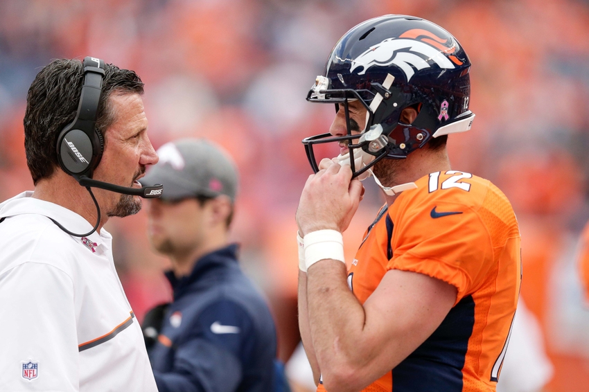 Oct 9, 2016; Denver, CO, USA; Denver Broncos quarterback Paxton Lynch (12) talks with quarterbacks coach Greg Knapp in the third quarter against the Atlanta Falcons at Sports Authority Field at Mile High. The Falcons won 23-16. Mandatory Credit: Isaiah J. Downing-USA TODAY Sports